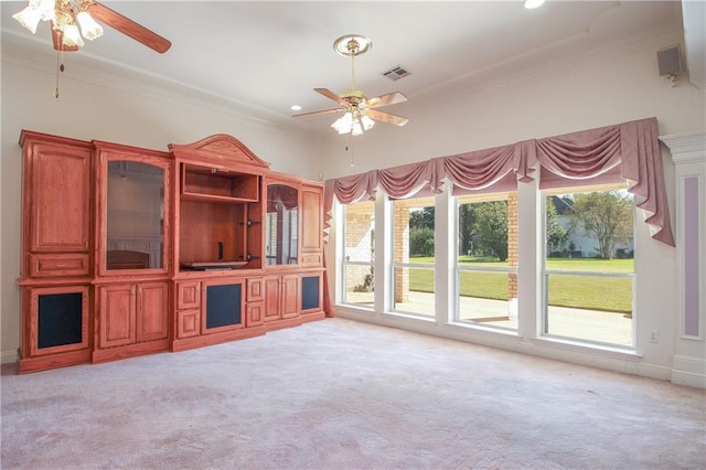 unfurnished living room with light carpet, crown molding, and ceiling fan