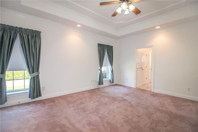 spare room with crown molding, light colored carpet, and ceiling fan