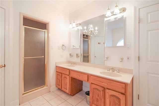 bathroom featuring a shower with door, vanity, crown molding, and tile patterned flooring