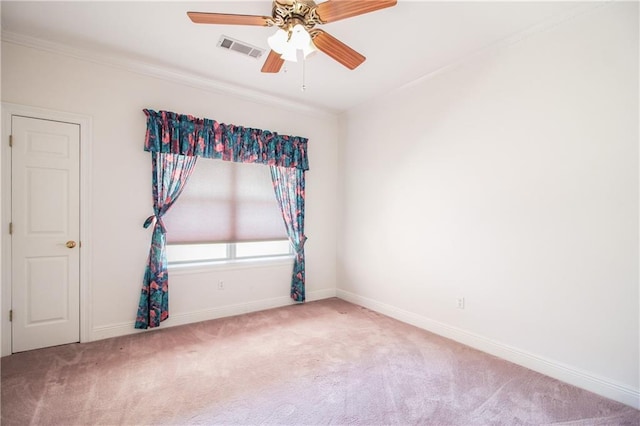 carpeted spare room featuring ceiling fan and crown molding