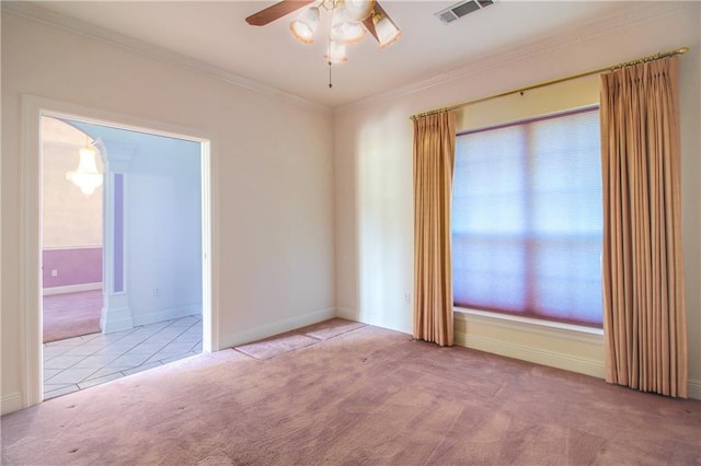 carpeted spare room with ceiling fan and ornamental molding