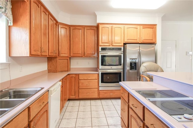 kitchen featuring sink, crown molding, appliances with stainless steel finishes, and light tile patterned floors