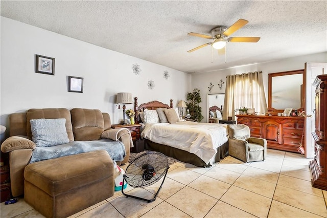 tiled bedroom with ceiling fan and a textured ceiling