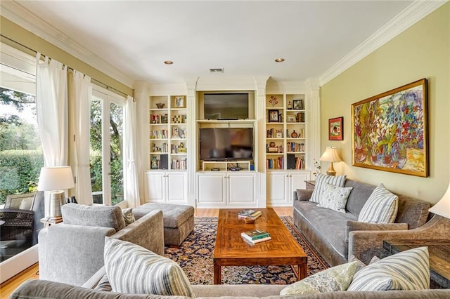 living room with crown molding, built in shelves, and wood-type flooring