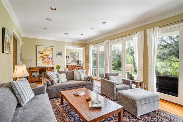 living room featuring hardwood / wood-style floors and crown molding