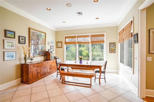 dining space featuring a wealth of natural light, light tile patterned floors, and crown molding