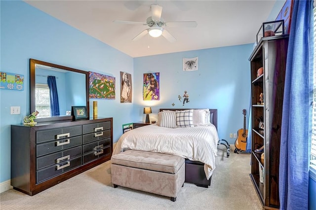 bedroom featuring light carpet and ceiling fan