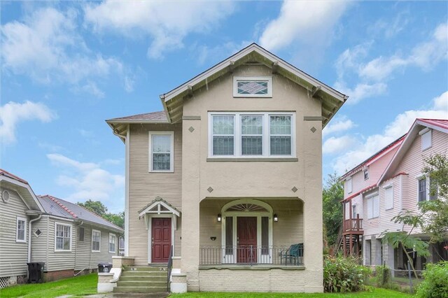 561214 Woodlawn Pl, New Orleans, LA 70124 - view of front of home with stucco siding, a front yard, and a porch