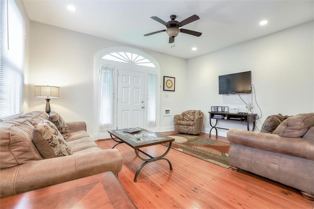 living room featuring hardwood / wood-style flooring and ceiling fan