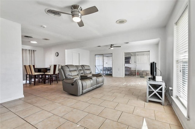 1005 35 Th St, Gretna, LA 70053 - living area featuring light tile patterned floors, ceiling fan, visible vents, and a healthy amount of sunlight