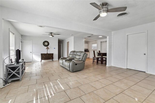 1005 35 Th St, Gretna, LA 70053 - living area featuring visible vents, a ceiling fan, and light tile patterned floors