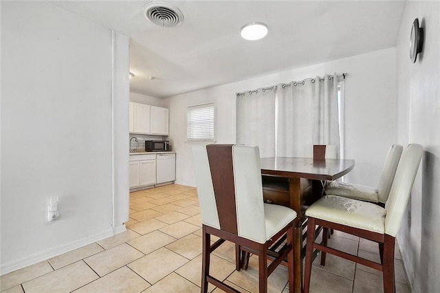 dining room with sink and light tile patterned floors