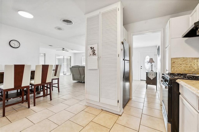 1005 35 Th St, Gretna, LA 70053 - kitchen with visible vents, ceiling fan, light tile patterned floors, and gas stove