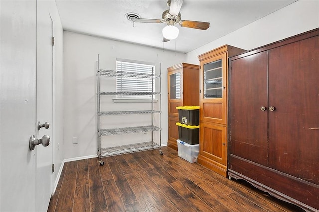 interior space featuring ceiling fan and dark hardwood / wood-style flooring