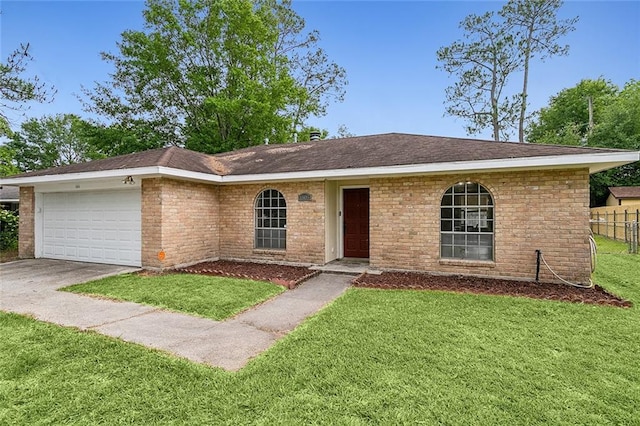 single story home with a garage and a front lawn