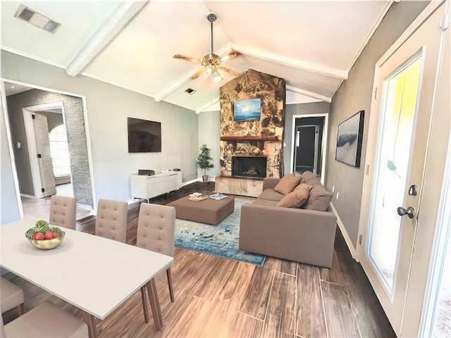 living room with a fireplace, dark hardwood / wood-style flooring, lofted ceiling with beams, and ceiling fan