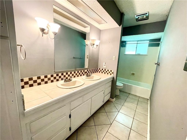 bathroom with vanity, tile patterned floors, decorative backsplash, toilet, and a textured ceiling