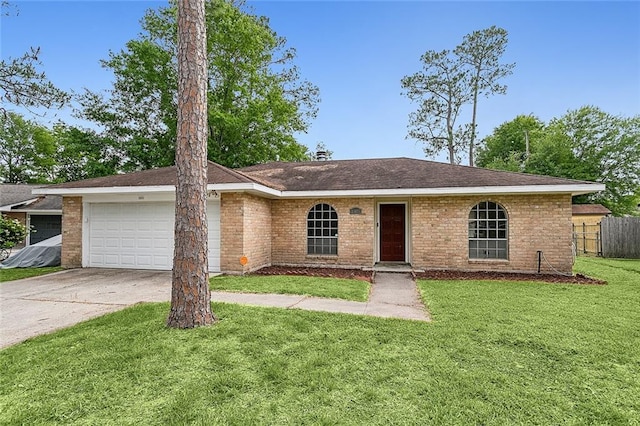 ranch-style house with a garage and a front yard