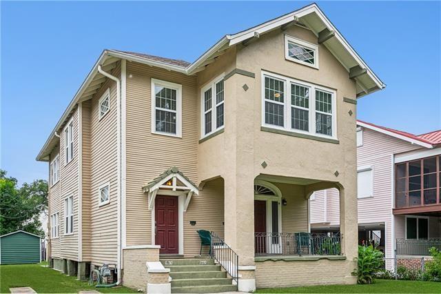 5612 Woodlawn Pl, New Orleans, LA 70124 - view of front of property featuring a front lawn, a porch, and stucco siding