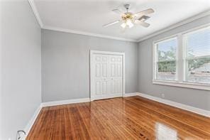 5612 Woodlawn Pl, New Orleans, LA 70124 - unfurnished bedroom featuring ornamental molding, wood finished floors, a closet, baseboards, and ceiling fan