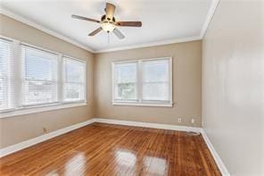 unfurnished room featuring hardwood / wood-style floors, crown molding, and ceiling fan