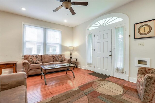 living room featuring light hardwood / wood-style floors and ceiling fan