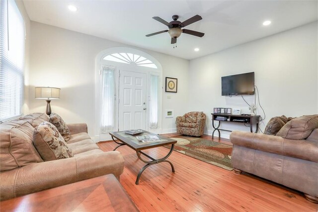 living room with hardwood / wood-style floors and ceiling fan