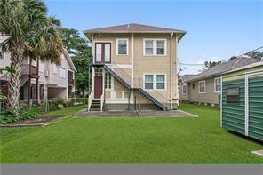 5612 Woodlawn Pl, New Orleans, LA 70124 - rear view of house featuring a lawn