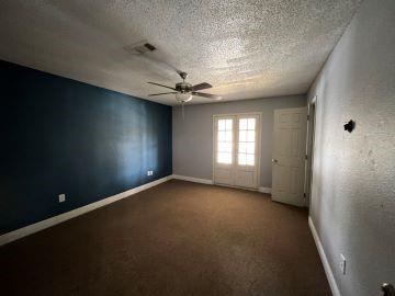 unfurnished room with french doors, ceiling fan, a textured ceiling, and carpet flooring