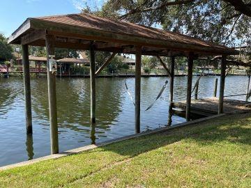 dock area with a yard and a water view