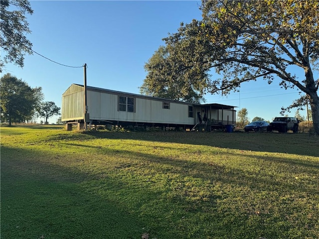 rear view of property with a sunroom and a lawn