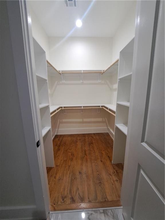 walk in closet featuring dark wood-type flooring