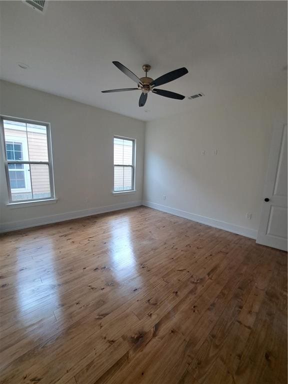 unfurnished room featuring ceiling fan and light hardwood / wood-style flooring