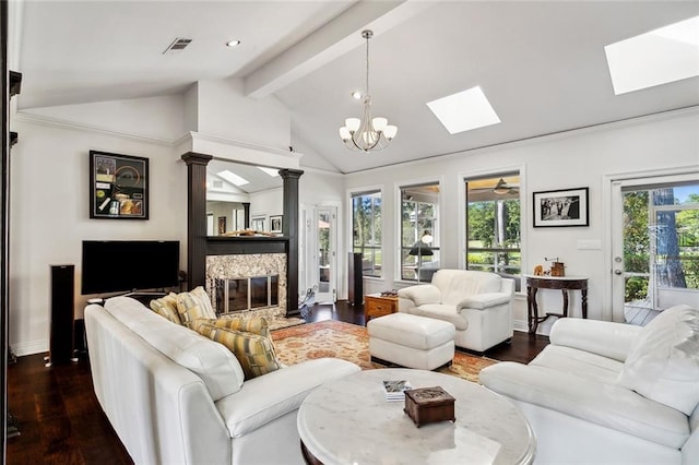 living room featuring lofted ceiling with beams, dark hardwood / wood-style flooring, and ceiling fan with notable chandelier