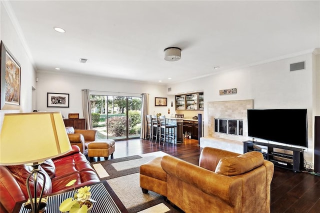 living room featuring crown molding and dark hardwood / wood-style flooring