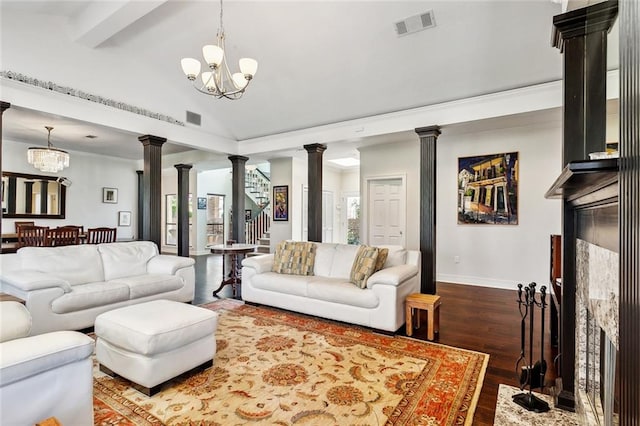 living room featuring vaulted ceiling with beams, a notable chandelier, ornate columns, and dark hardwood / wood-style flooring