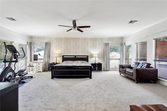 bedroom with ceiling fan, crown molding, and carpet flooring