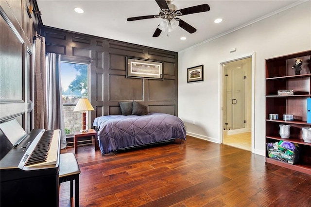 bedroom with ornamental molding, dark wood-type flooring, and ceiling fan