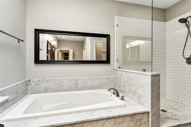 bathroom featuring separate shower and tub