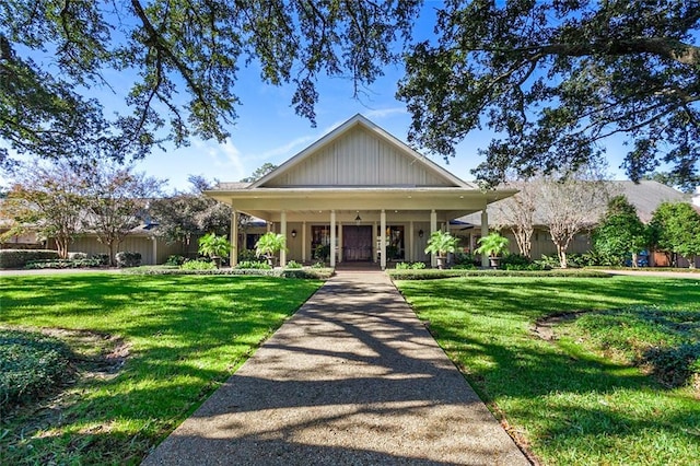 view of front of property featuring covered porch and a front yard