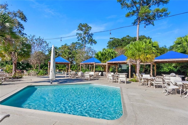 view of swimming pool featuring a patio and a gazebo