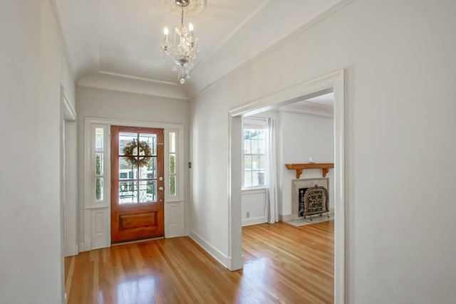 foyer entrance featuring light hardwood / wood-style flooring and a notable chandelier