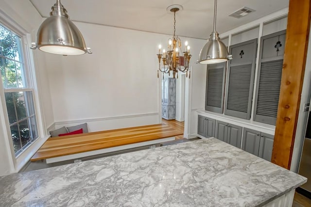 dining space featuring a notable chandelier and wood-type flooring