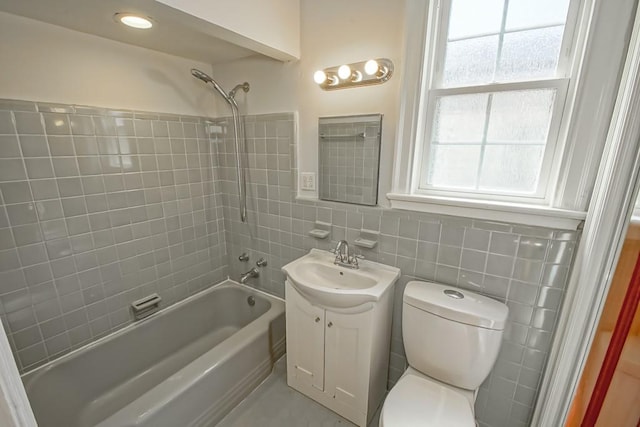 full bathroom with plenty of natural light, vanity, tile walls, and toilet