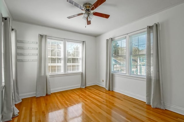 spare room featuring hardwood / wood-style flooring, plenty of natural light, and ceiling fan