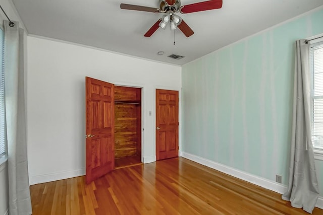 unfurnished bedroom featuring ceiling fan and hardwood / wood-style flooring