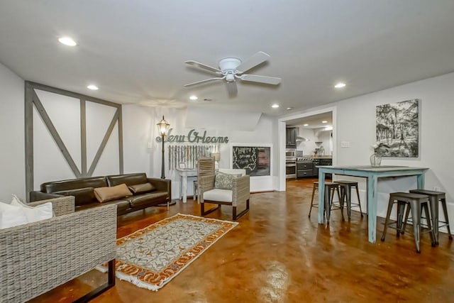 living room with ceiling fan and concrete floors