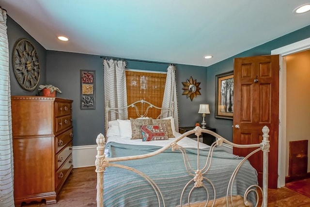 bedroom with hardwood / wood-style flooring