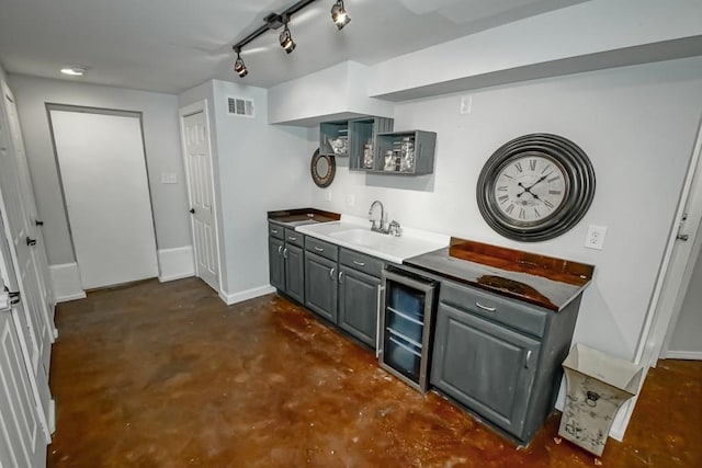 bar with gray cabinetry, sink, and wine cooler