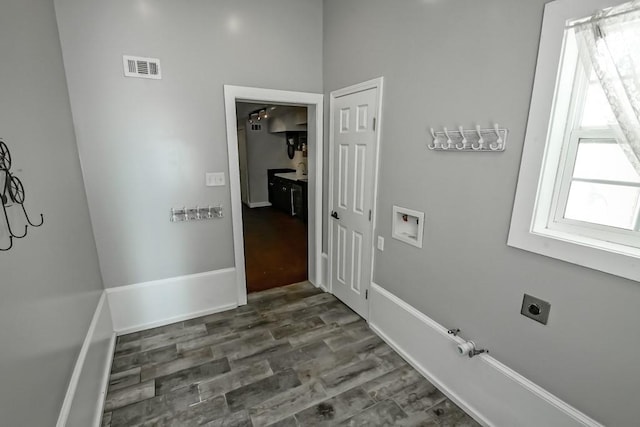 laundry room featuring hookup for an electric dryer, washer hookup, dark hardwood / wood-style floors, and gas dryer hookup